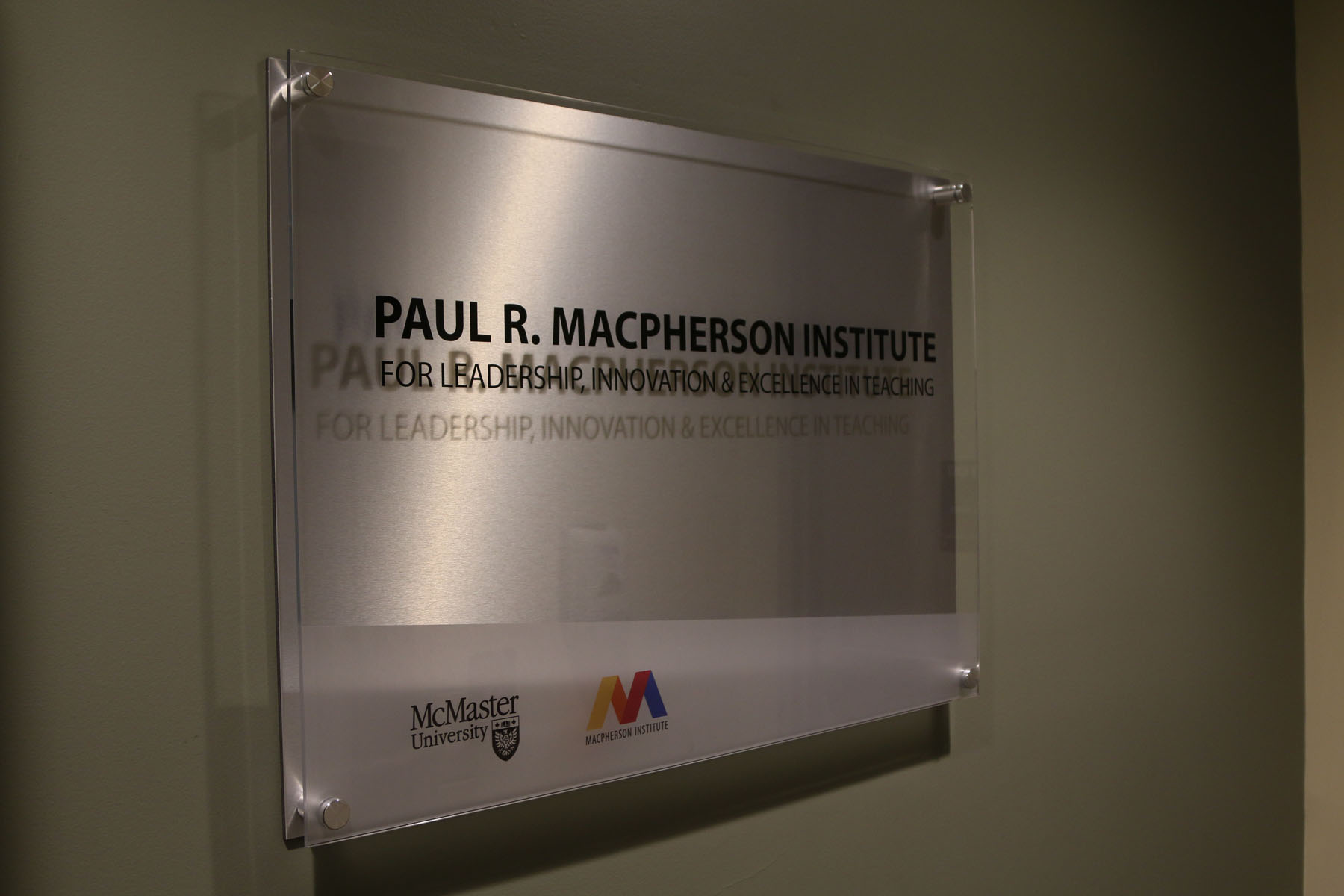 Metallic sign displaying the name 