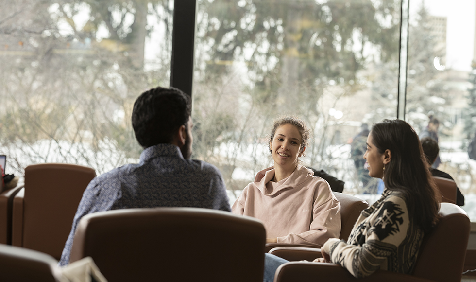 Students sitting and talking at McMaster's Health Sciences Library