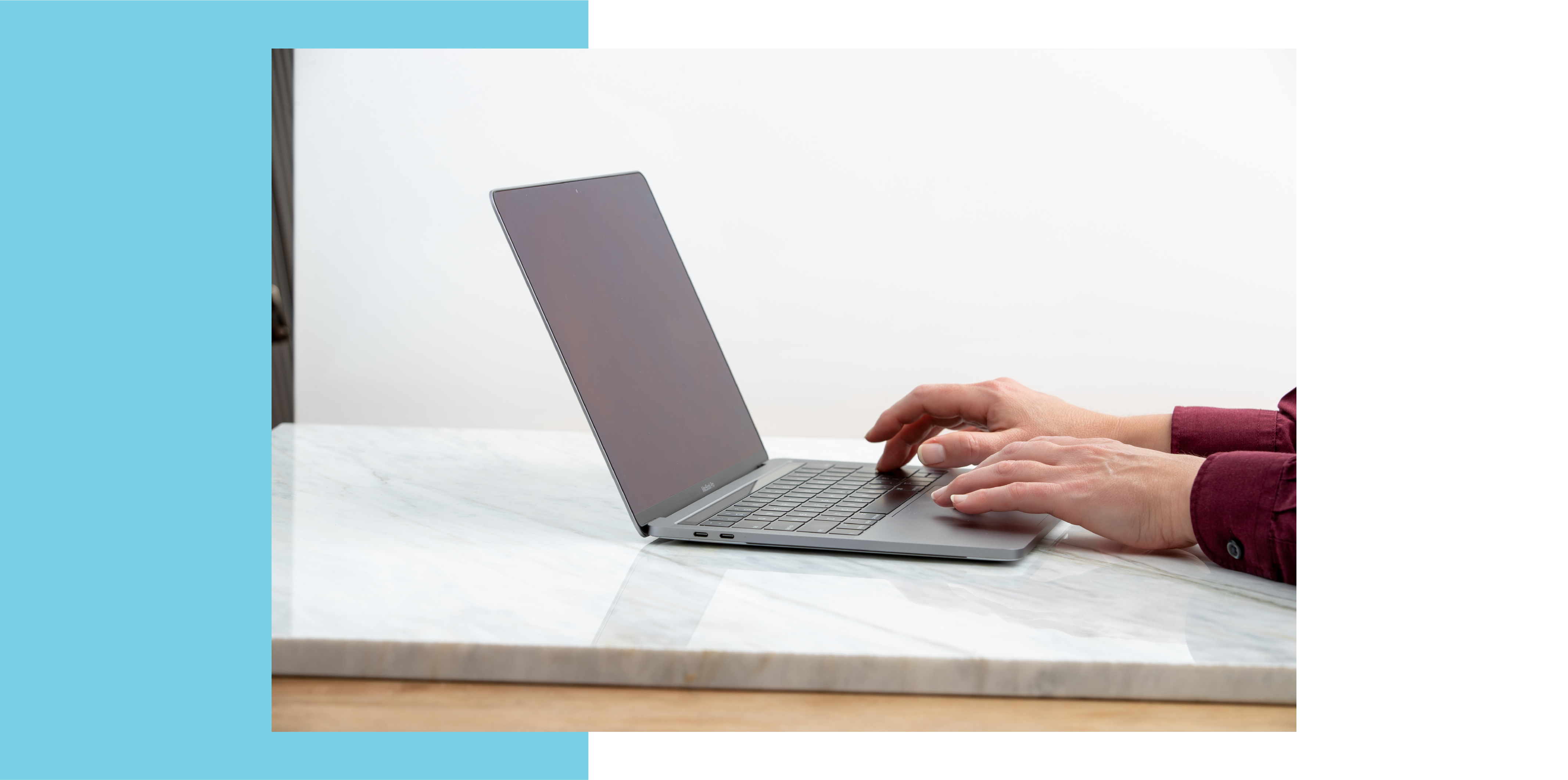 Image of hands typing on laptop.