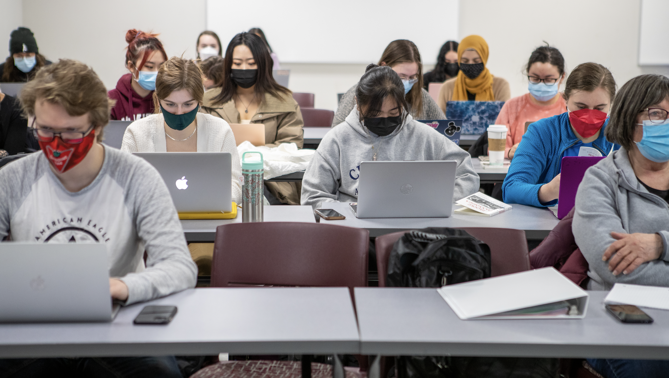 students in classroom using laptops