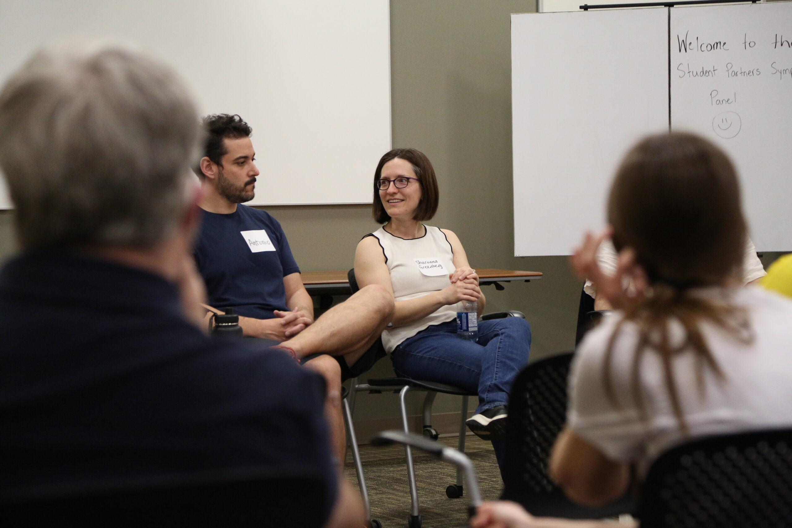 A group of educators sit in a circle and talk