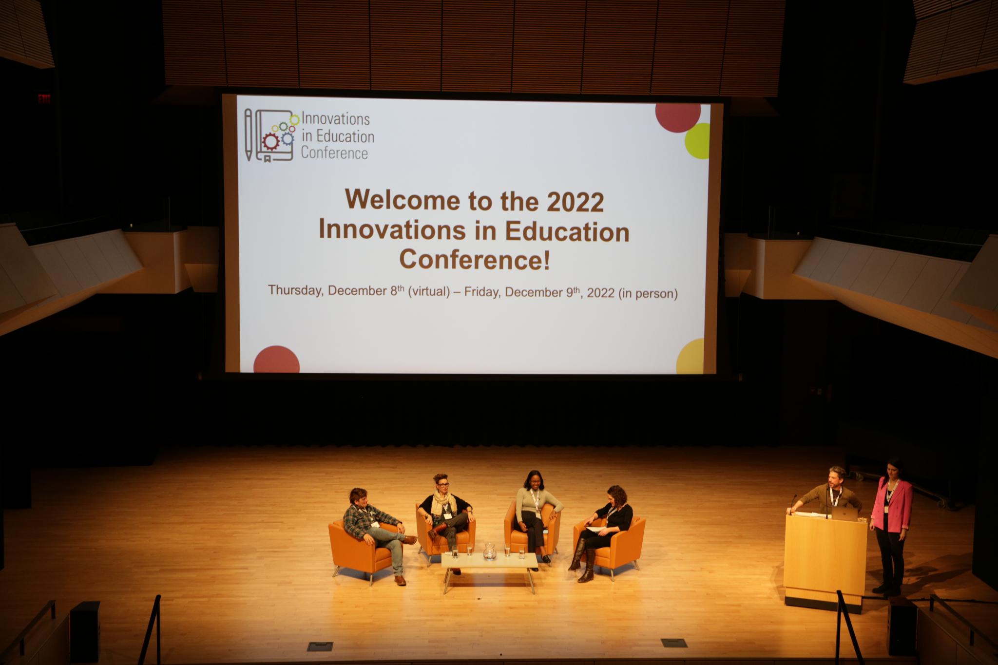 Stage view of host and panellists during the Innovations in Education Conference at McMaster
