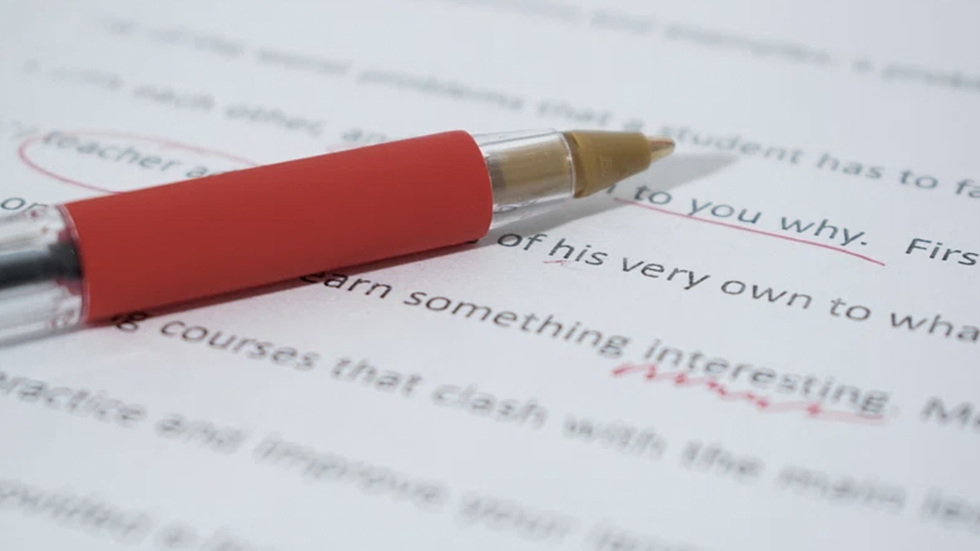 Pen resting on Essay