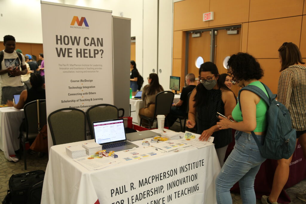 Table and banner promoting the MacPherson Institute. The banner says 